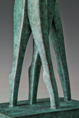 Close-up of the elongated bronze legs and textured green patina of the couple sculpture