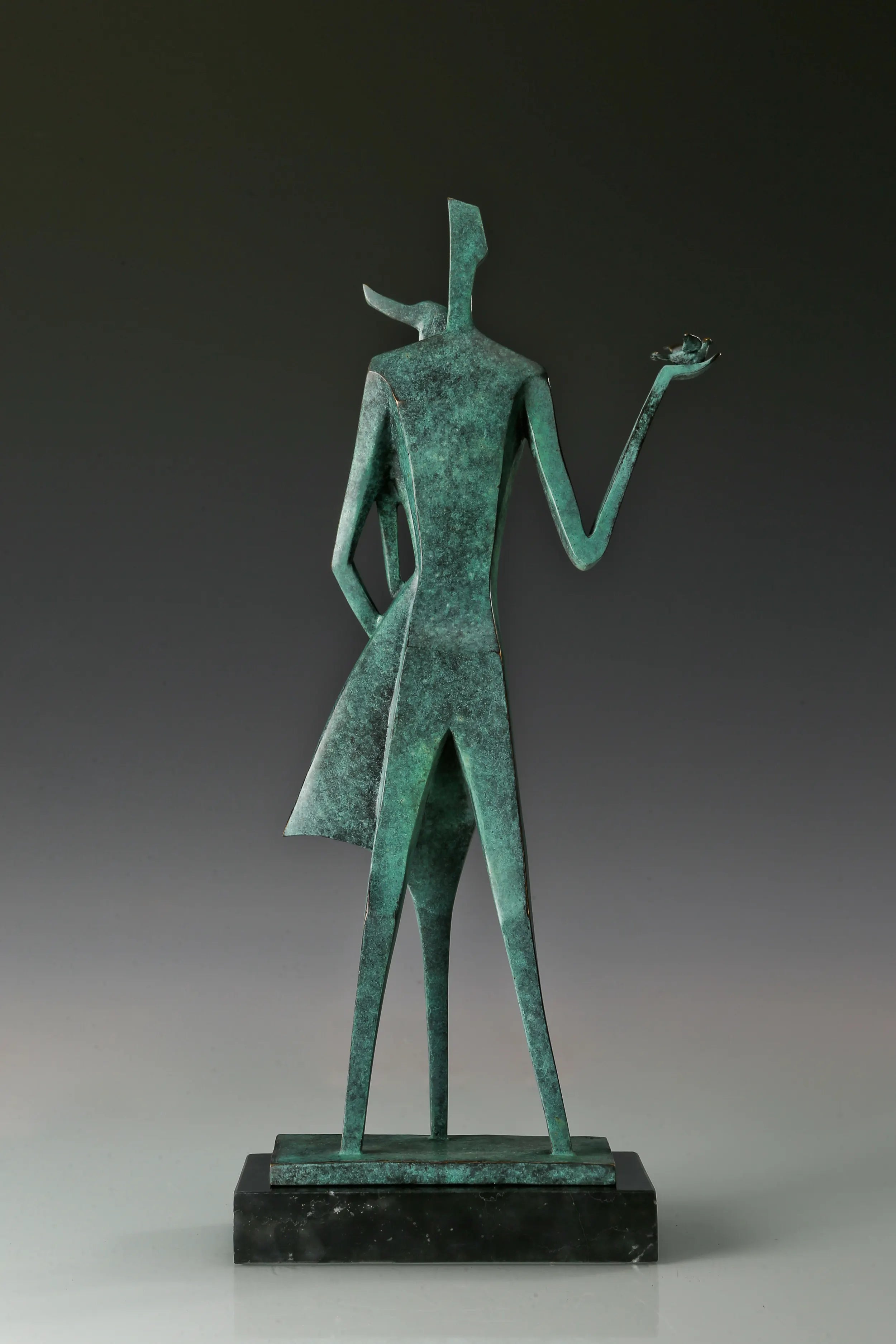 Back view of abstract bronze couple statue showing its angular forms and green patina