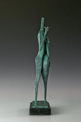 Left side view of two stylized bronze figures standing together on a black marble base