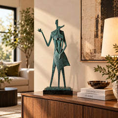 Abstract couple with bird bronze sculpture displayed on a wooden sideboard in a modern living room