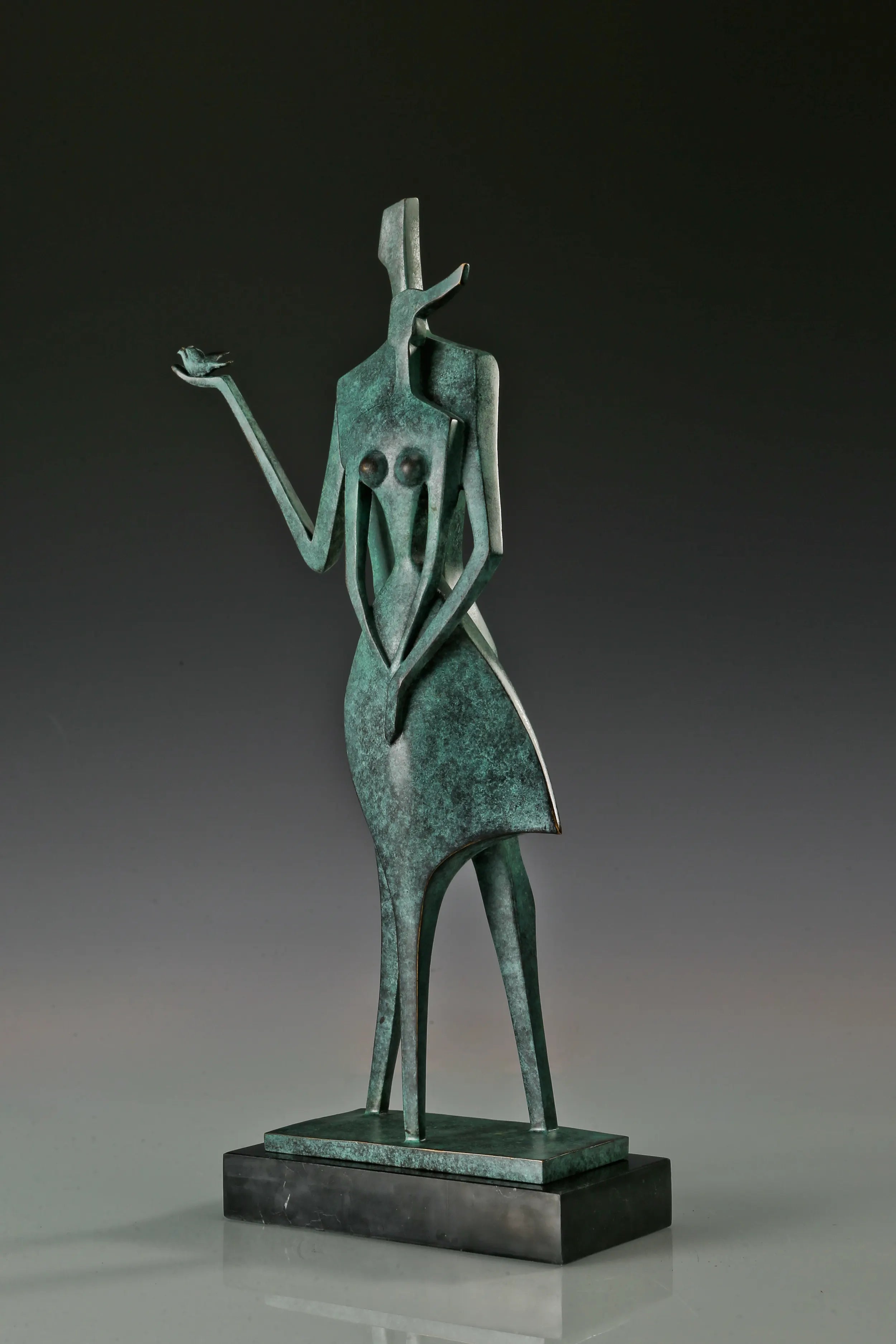 Right angled view of abstract couple bronze statue showing the overlapping figures and raised arm