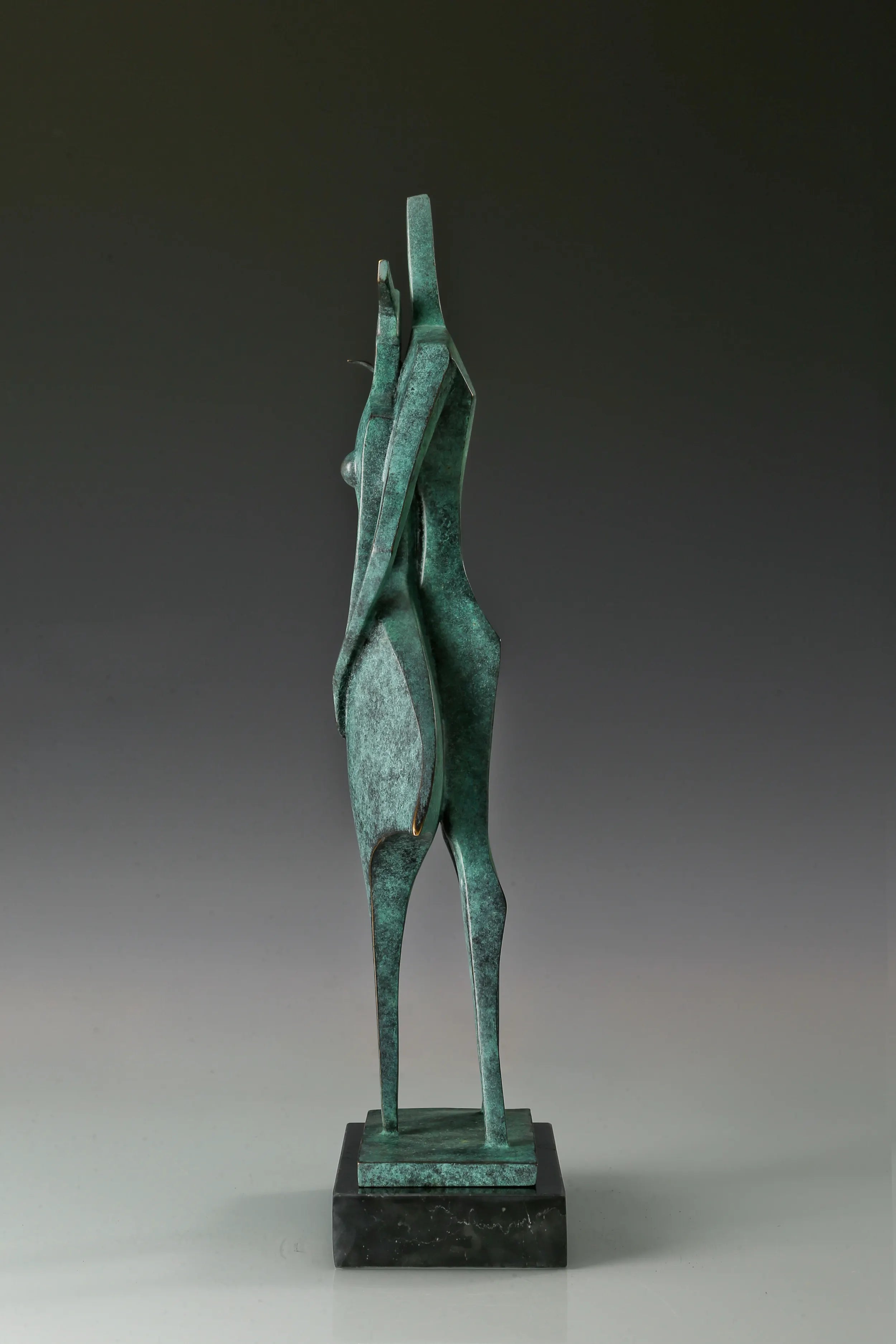 Side view of contemporary bronze couple sculpture with elongated geometric silhouettes