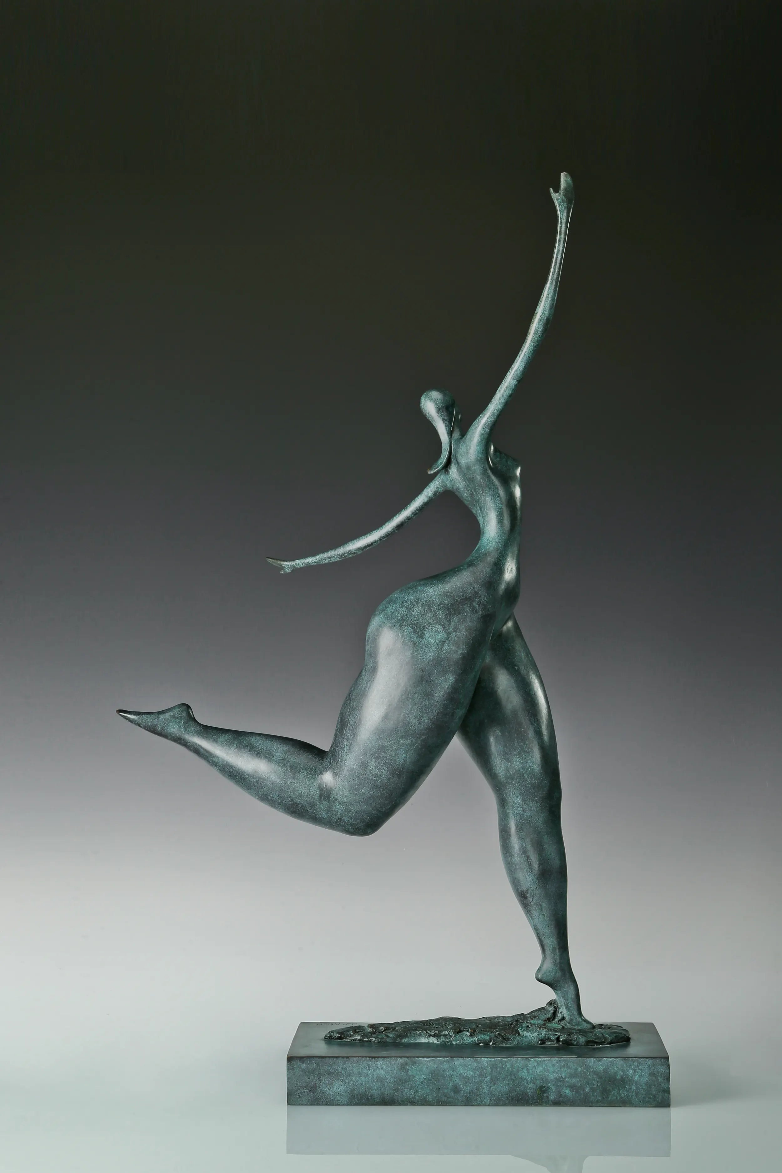Right side view of abstract bronze dancer with flowing elongated proportions