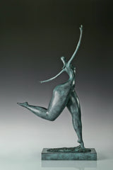 Right side view of abstract bronze dancer with flowing elongated proportions