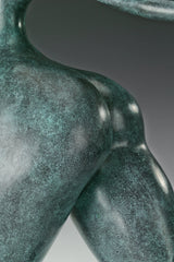 Close-up of the rounded hip on the abstract dancing female bronze sculpture