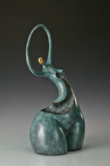 Three-quarter view of abstract female bronze sculpture with gold-toned facial accent
