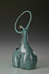 Rear three-quarter view of abstract dancing woman statue showing its sculptural curves