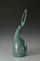 Side profile of abstract bronze dancer showing the tall circular upper form