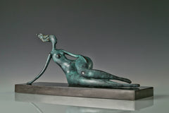 Angled view of abstract reclining woman sculpture showing her relaxed pose
