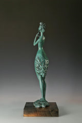 Side profile of abstract bronze woman playing a flute on a wooden base