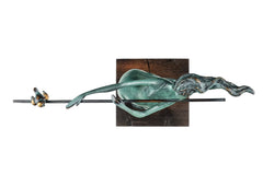 Overhead view of abstract female flute player sculpture showing the flute, flowing hair, and wooden base