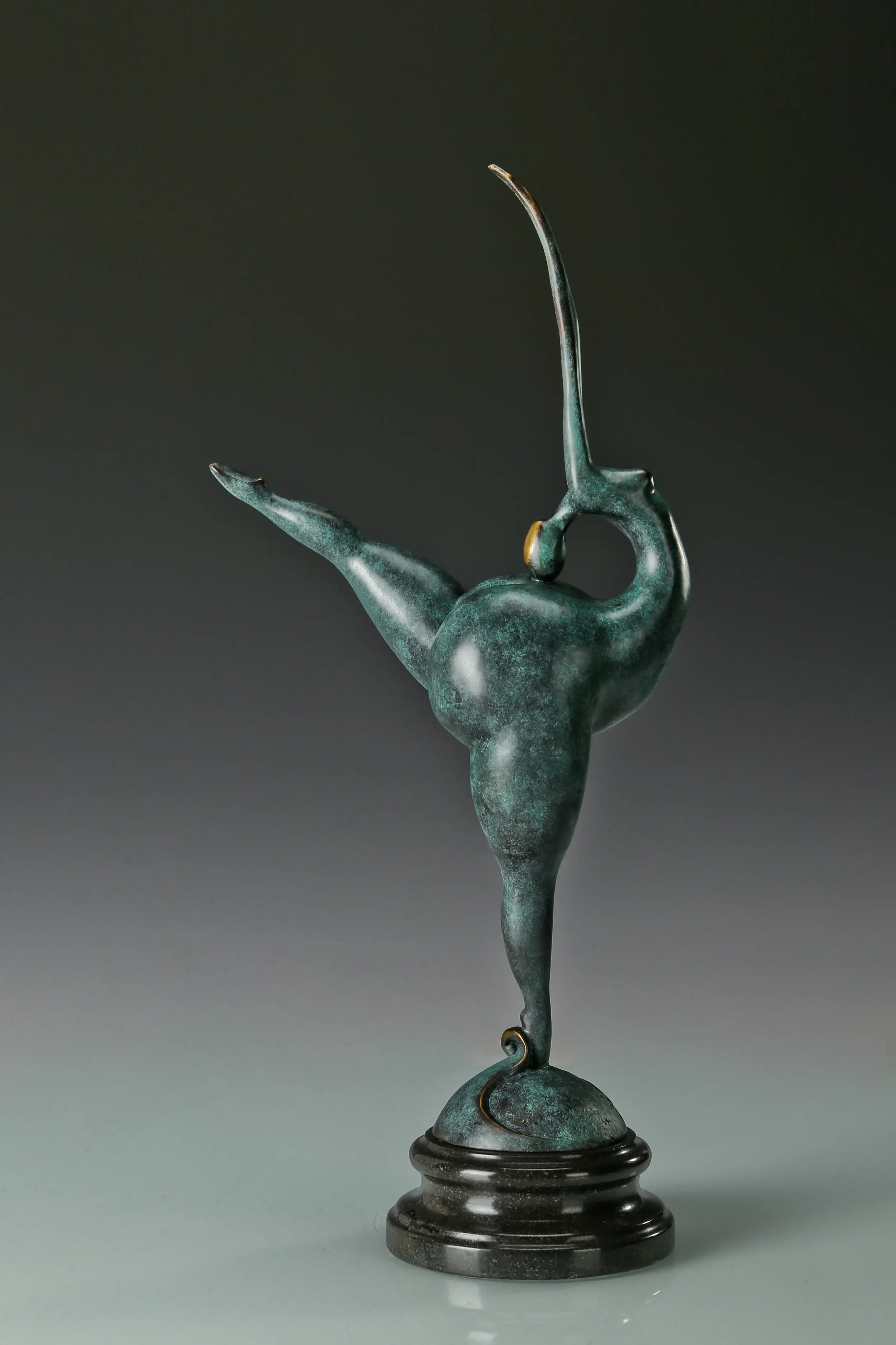 Front view of abstract gymnast bronze statue with green patina and black base
