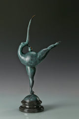 Opposite angled view of abstract gymnast sculpture with raised leg and green patina