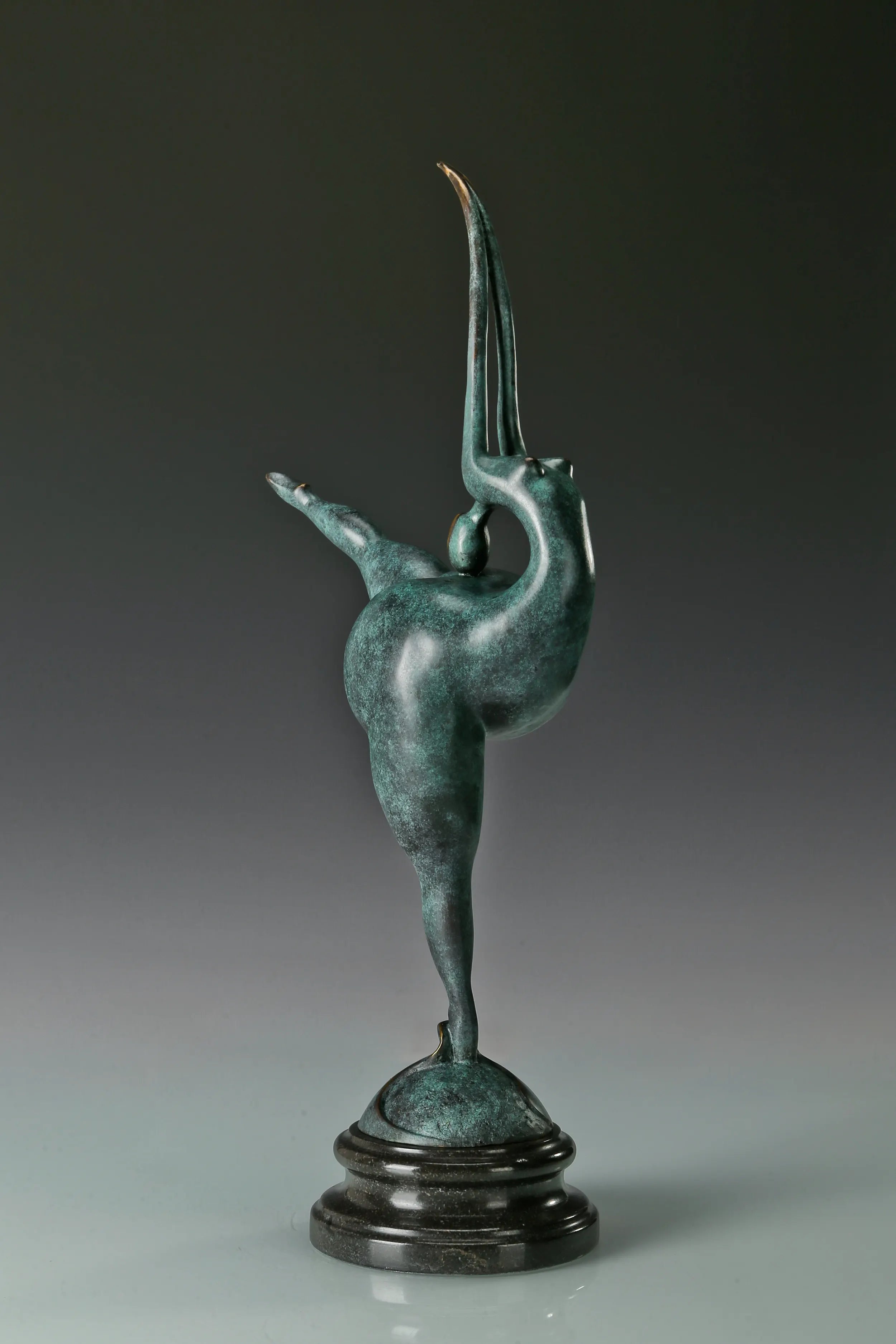 Three-quarter view of female gymnast bronze sculpture showing its extended leg