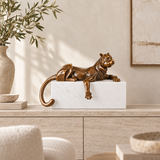 Abstract lying cat bronze sculpture displayed on a console table in a modern home interior