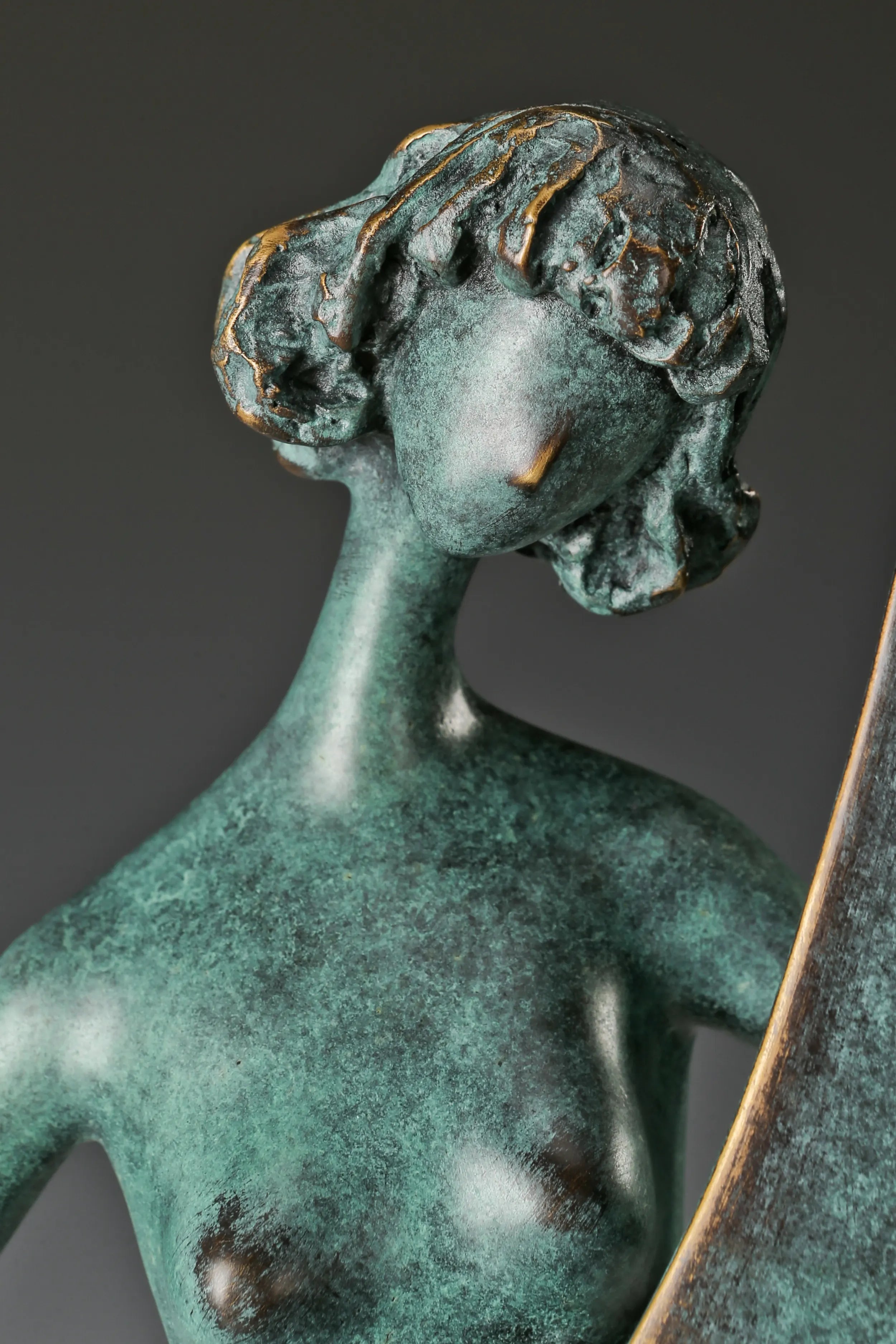 Close-up of the abstract female musician's softly tilted face and textured bronze hair