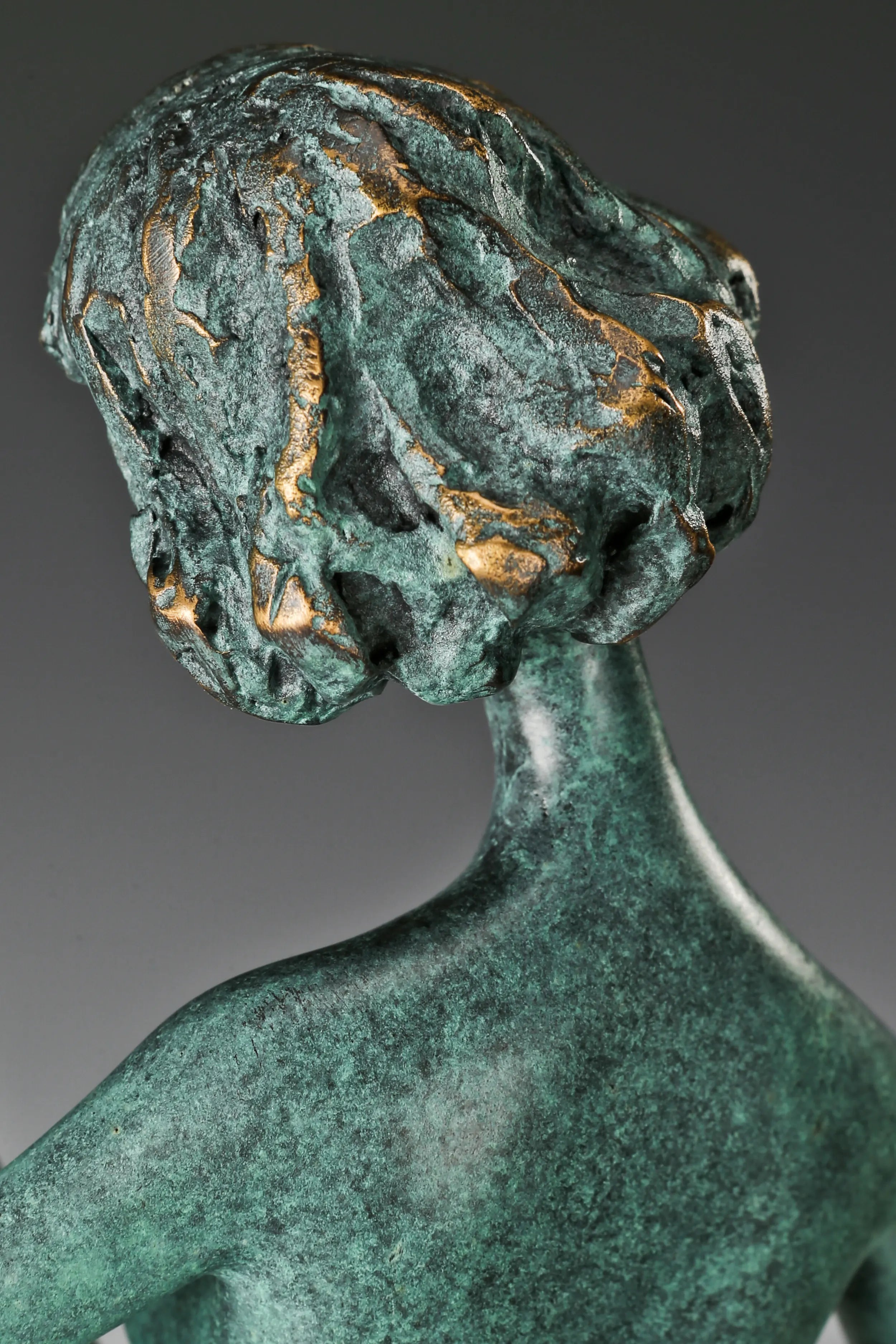 Close-up of the abstract female musician's softly tilted face and textured bronze hair