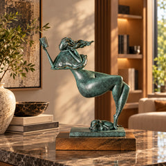 Abstract bronze reading woman with a book and sleeping dog displayed on a wooden side table in a cozy living room