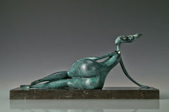 Rear view of abstract reclining female sculpture showing the curved body