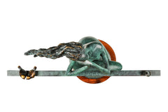 Top view of the abstract seated woman sculpture showing the horizontal bar, birds and wooden base