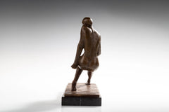 Rear view of abstract seated woman bronze sculpture showing textured back and rectangular base
