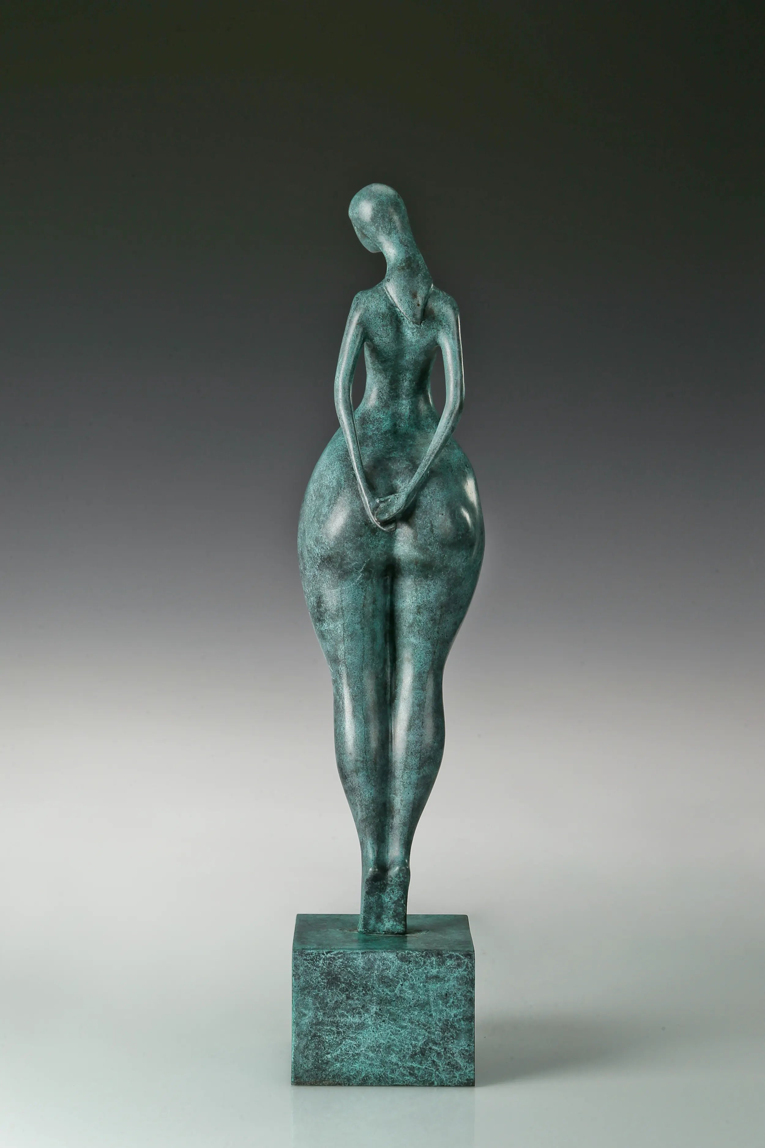 abstract bronze woman sculpture showing the sculpted back and body contours