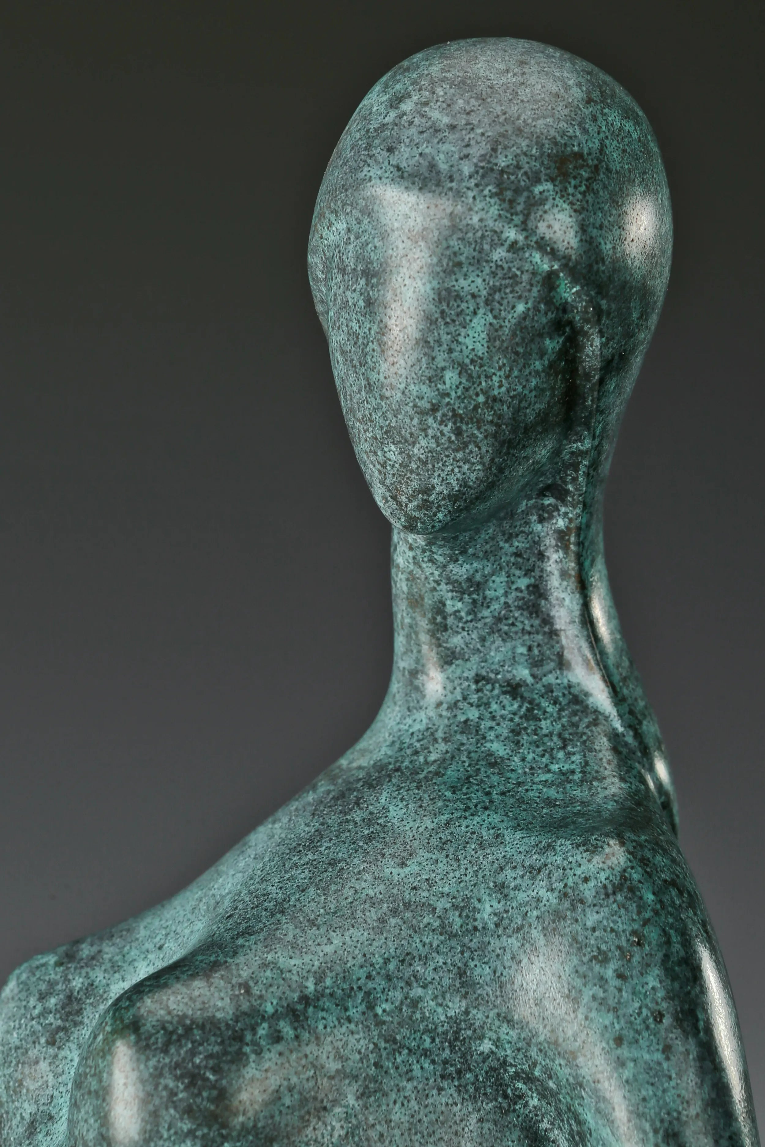 Close-up of abstract woman's smooth featureless face and elongated neck