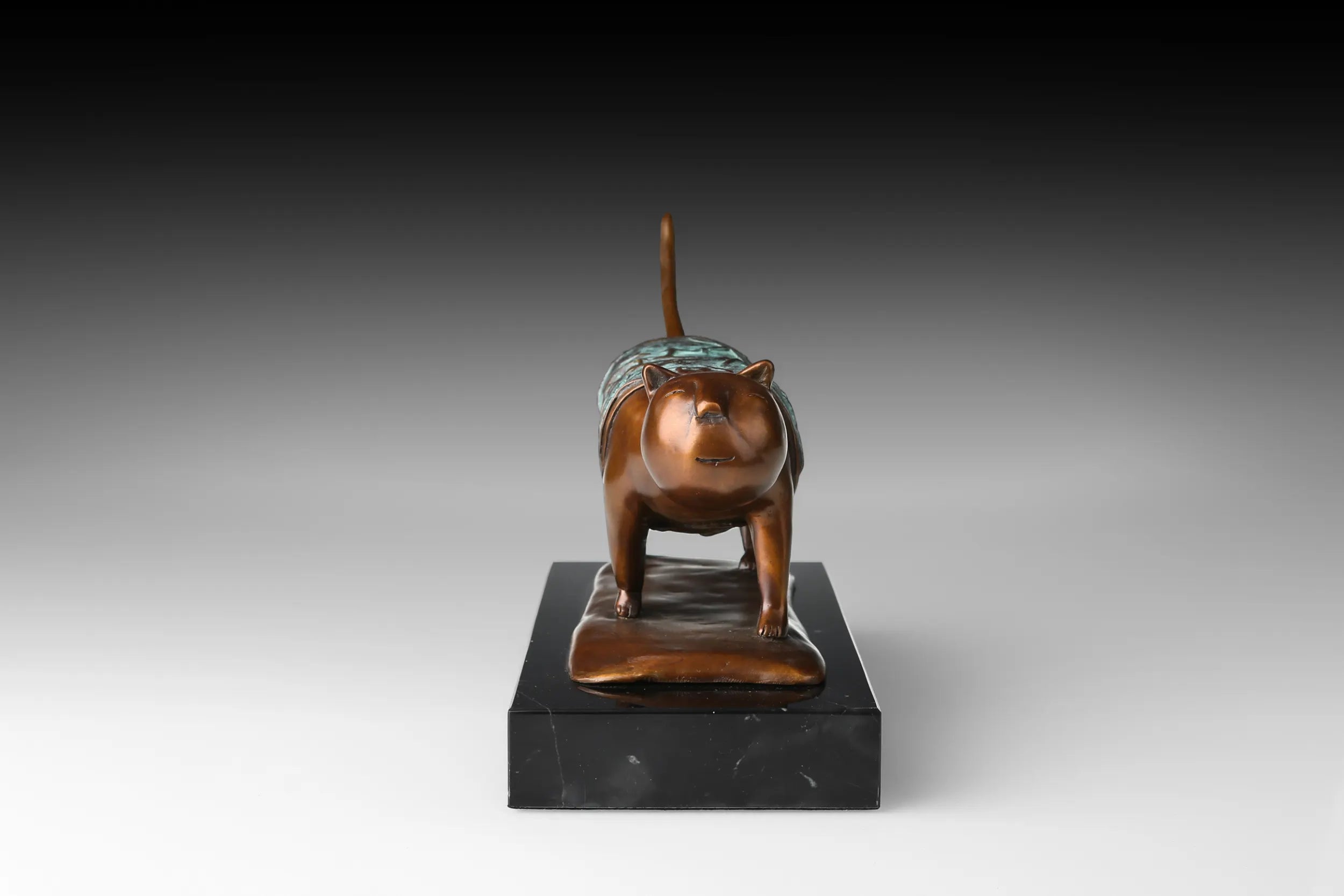 Close-up of the stylized face on abstract walking cat bronze sculpture