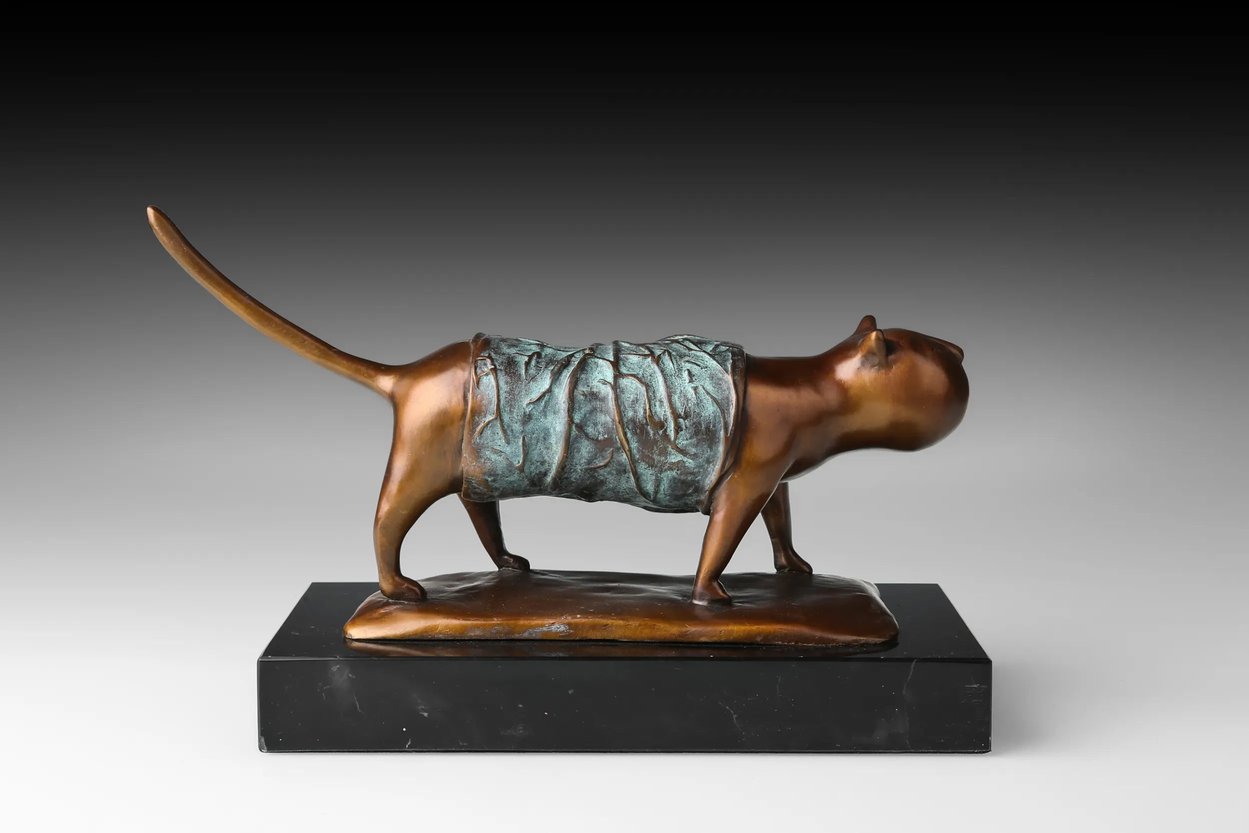 Right view of modern walking cat bronze statue on a marble base