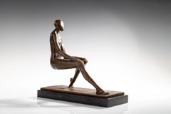Side profile of seated bronze woman with relaxed posture and crossed legs