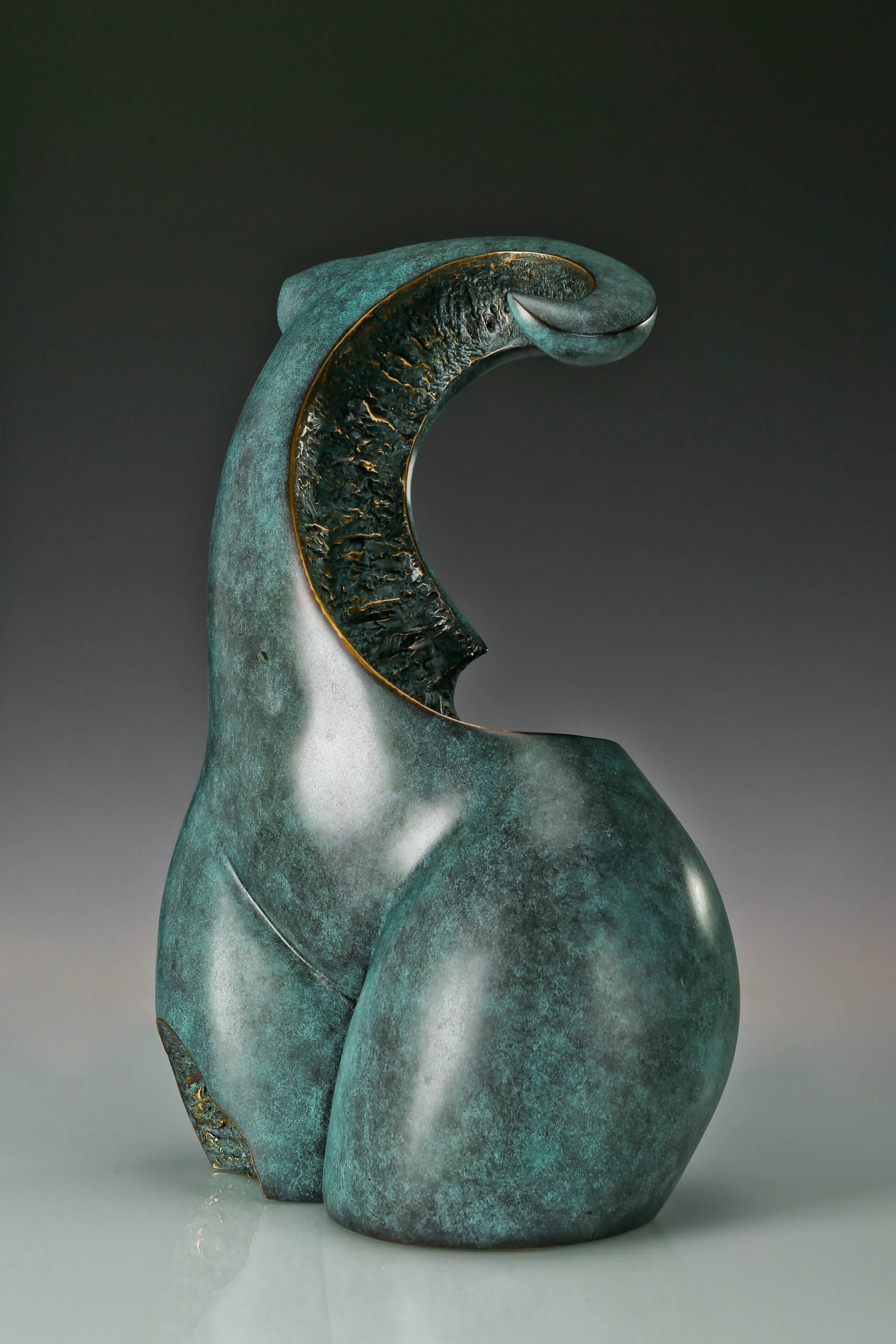 Three-quarter view of abstract woman torso bronze statue showing its curved upper form