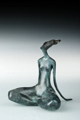 Angled view of bronze yoga woman sculpture showing its curved seated posture