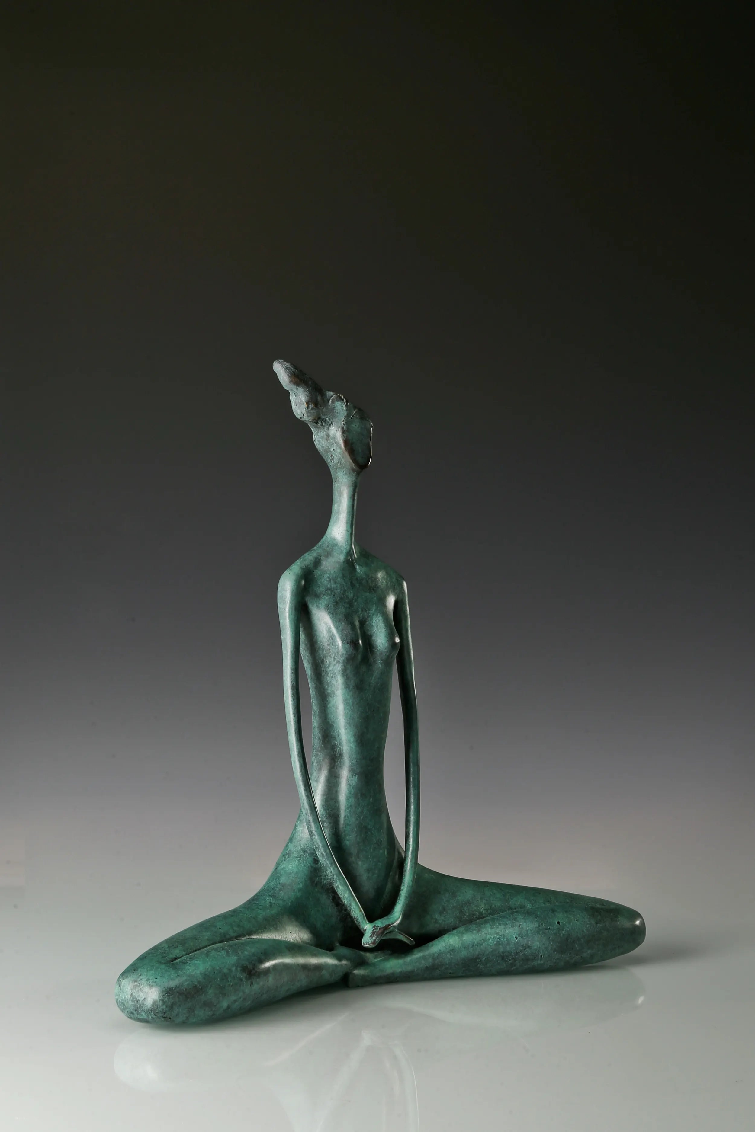 Three-quarter view of abstract yoga woman statue showing its sculpted silhouette