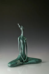 Three-quarter view of abstract yoga woman statue showing its sculpted silhouette