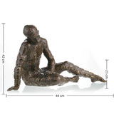 Contemporary bronze sculpture crouching male figure with chessboard symbols pattern, conceptual human form statue mid-movement, loss wax casting avant-garde art.