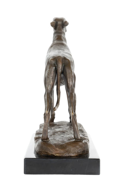 an elegant bronze sculpture of a greyhound, crafted using the lost-wax casting method . The piece captures the dog in a poised, alert stance, with its head held high and body stretched forward, conveying the breed’s characteristic grace, speed, and athleticism. The rich, warm bronze patina accentuates the dog’s lean, muscular physique, the smooth texture of its short coat, and the delicate details of its collar.