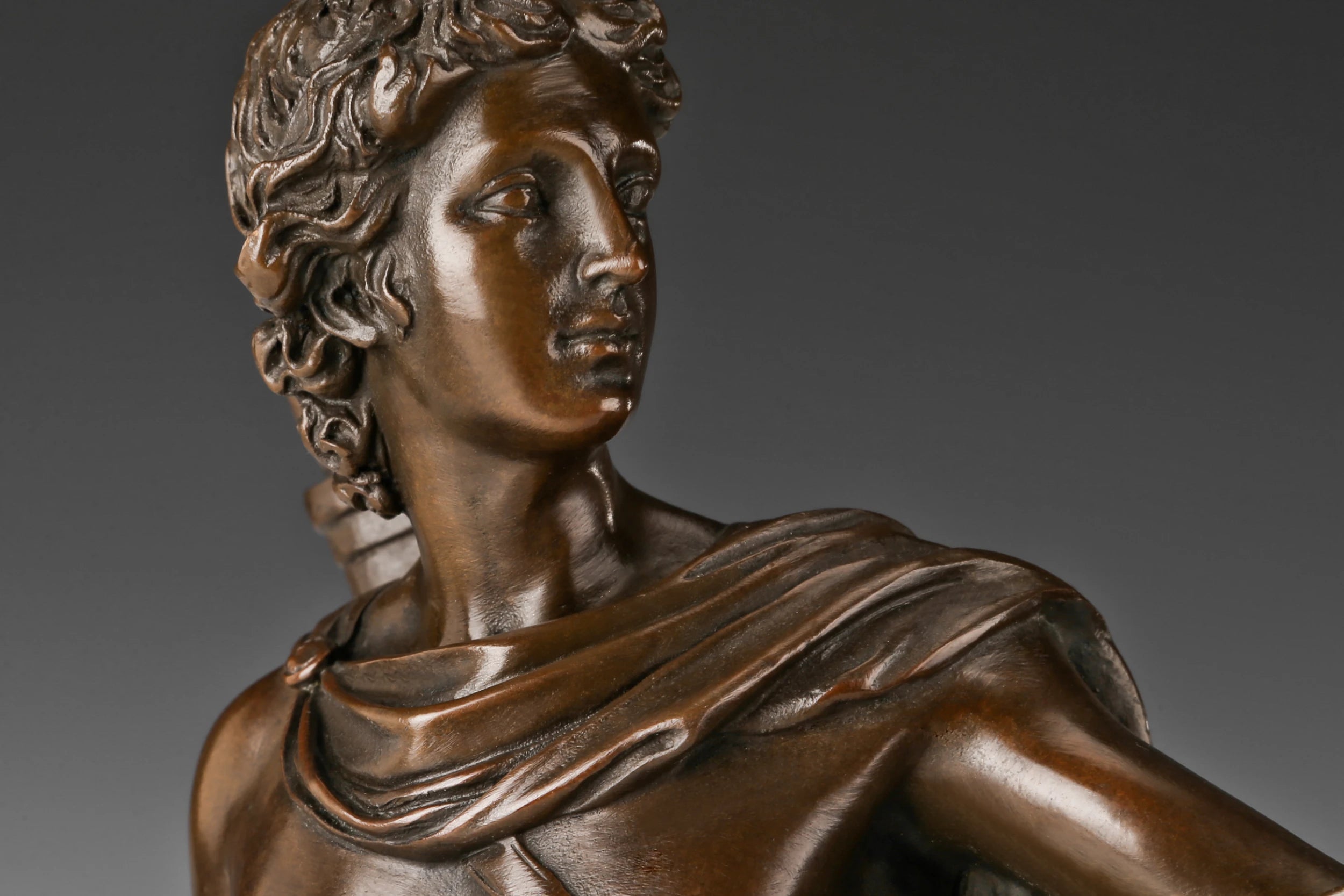 Close-up detail of Apollo bronze sculpture face and hair
