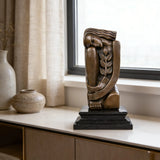 Art Deco seated female bronze sculpture with geometric design and olive branch detail