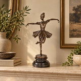 balancing ballerina bronze sculpture displayed in an elegant living room as decorative art