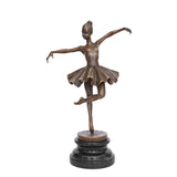 Front view of poised ballerina bronze sculpture balancing on one pointe shoe with arms extended