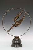 Angled view of bronze ballerina sculpture featuring a flowing tutu and circular frame