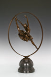 Back view of circular frame ballerina bronze sculpture showing the dancer's pose