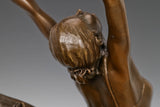 Close-up of the bronze ballerina figure with gracefully extended arms