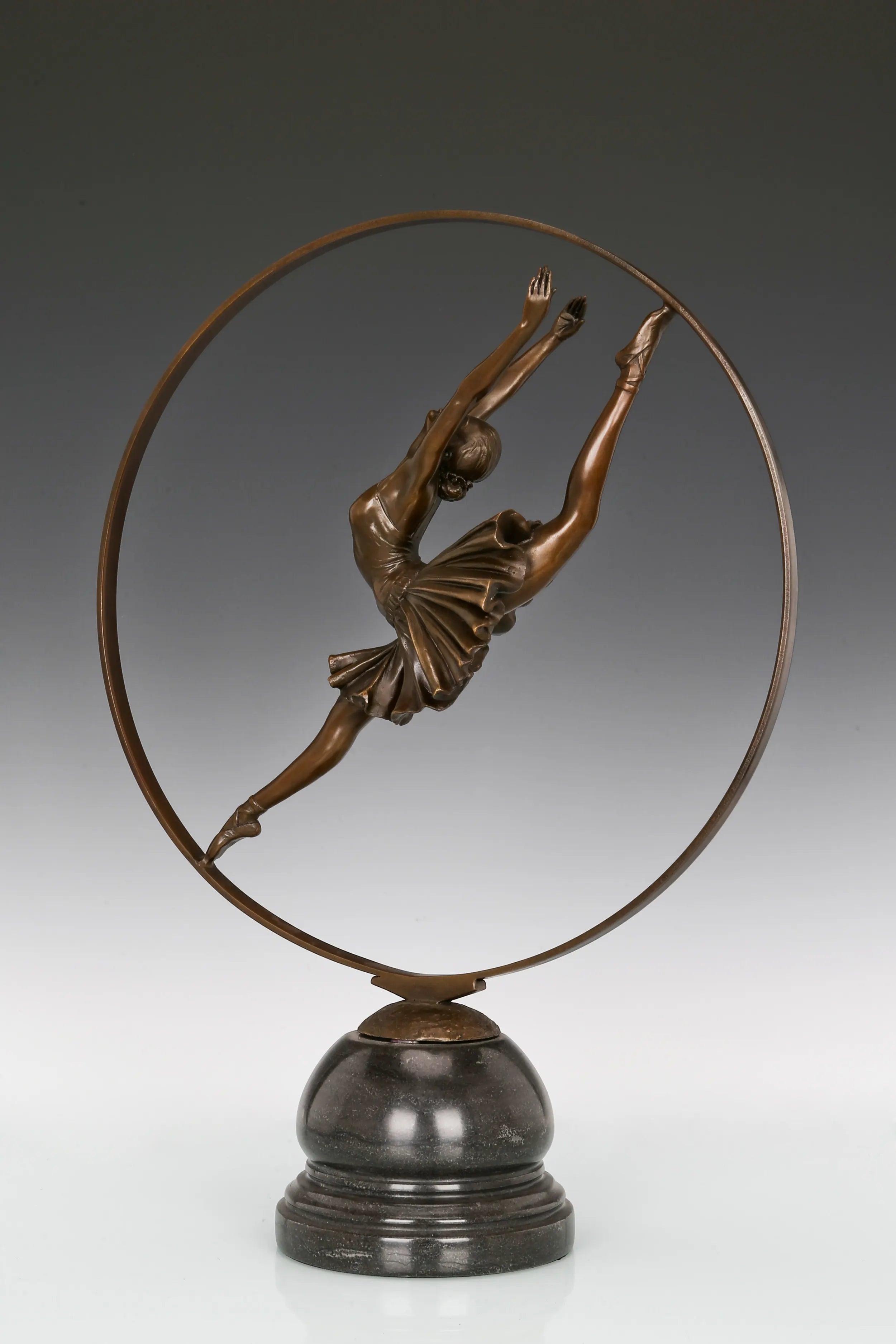 Three-quarter view of handcrafted ballerina bronze sculpture with circular design