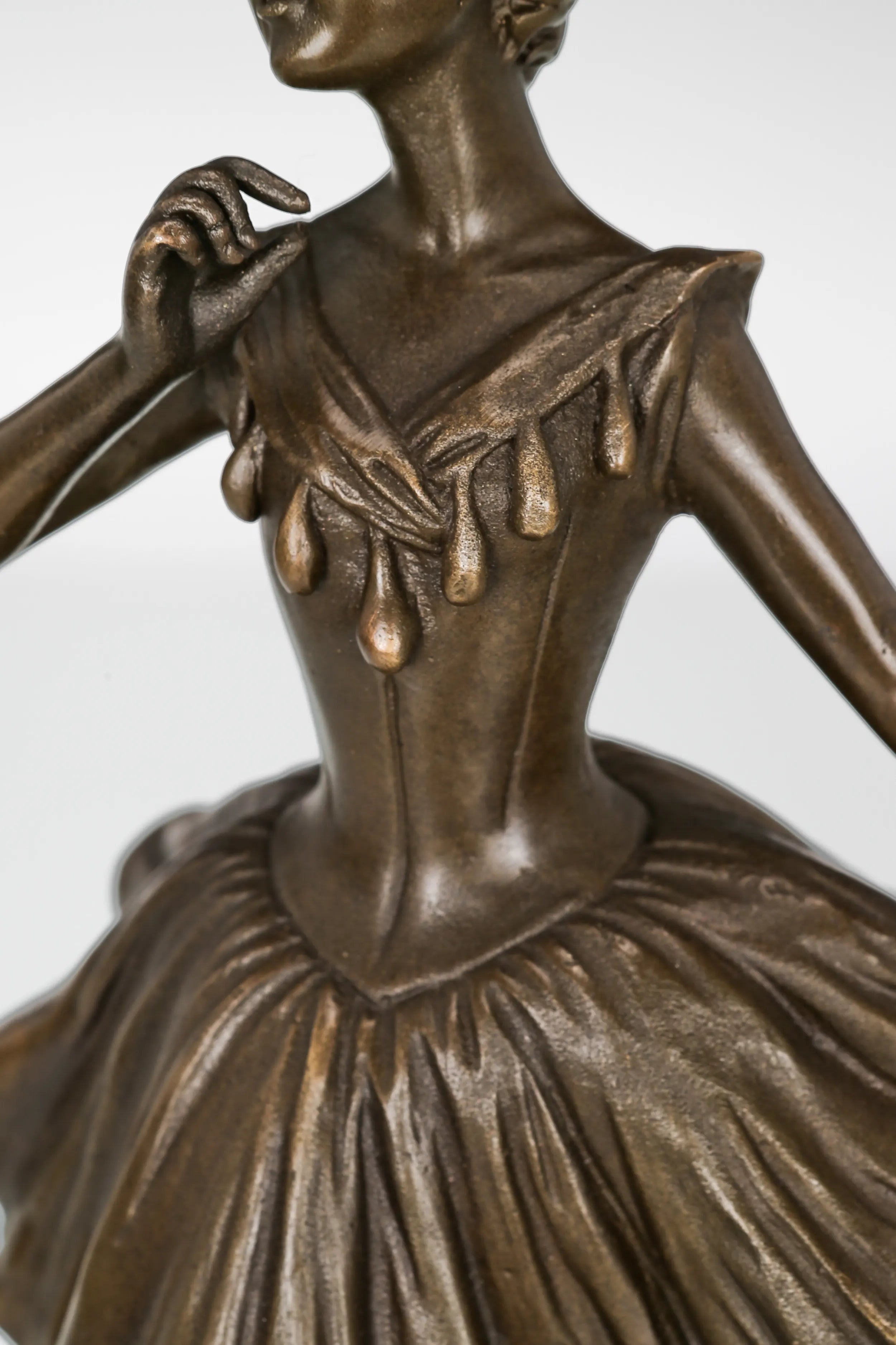 Detailed bronze ballet dress with flowing folds and decorative bodice