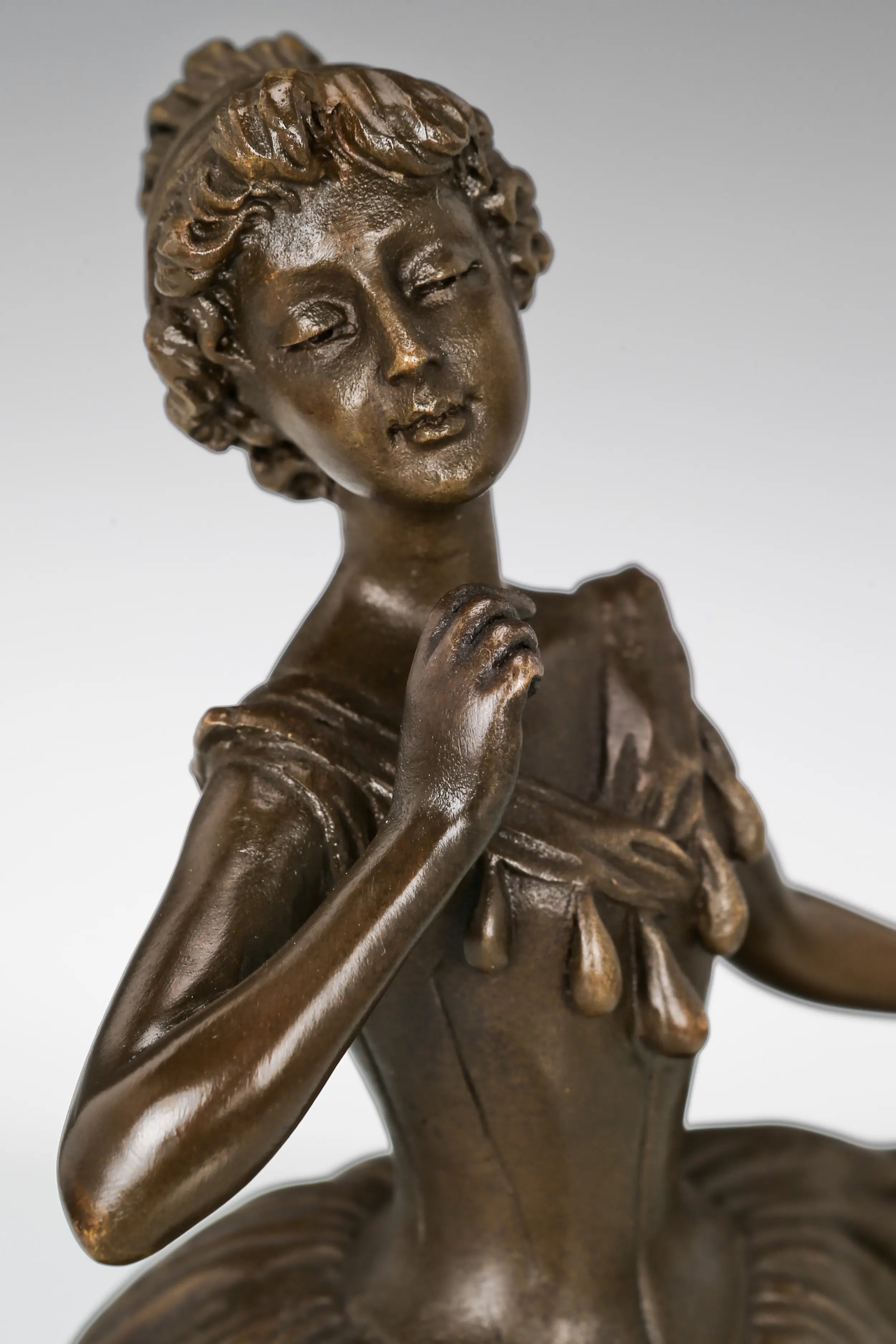 Close-up of the ballerina bronze sculpture showing her delicate facial expression