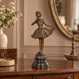 Ballerina holding dress bronze sculpture displayed in an elegant living room