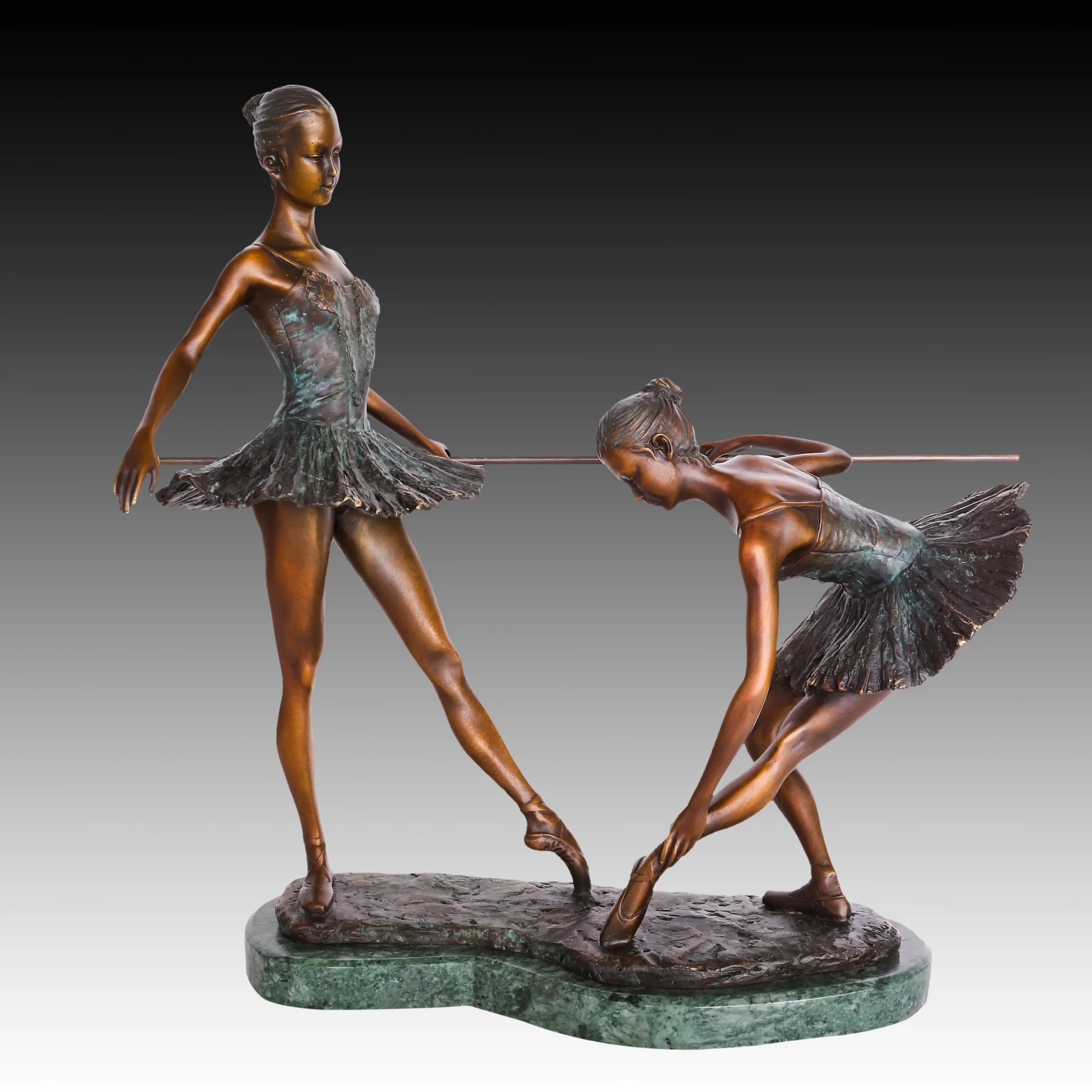 Front view of two ballerinas practicing at a ballet barre in a handcrafted bronze sculpture