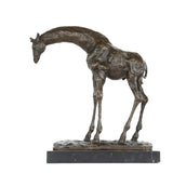 Left side view of bowing giraffe bronze statue on marble base
