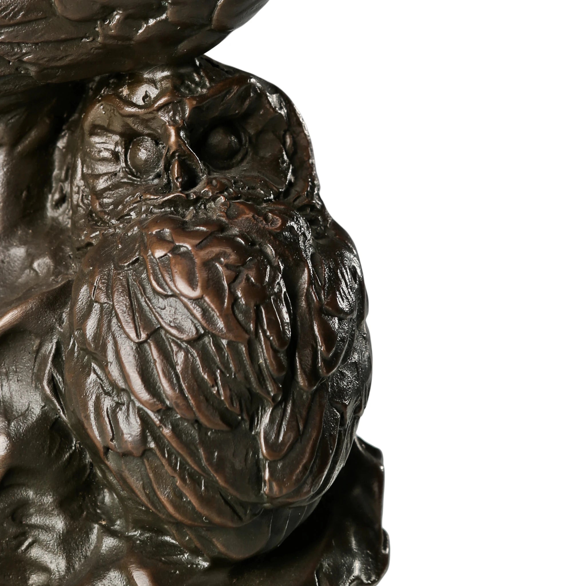 Close-up of baby owl in handcrafted bronze family sculpture with detailed plumage
